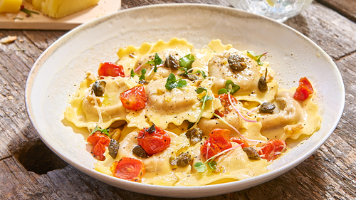 RAVIOLONES CAPRESSE CON TOMATITOS SALTEADOS, ACEITE VERDE Y GREMOLATTA DE PISTACHOS